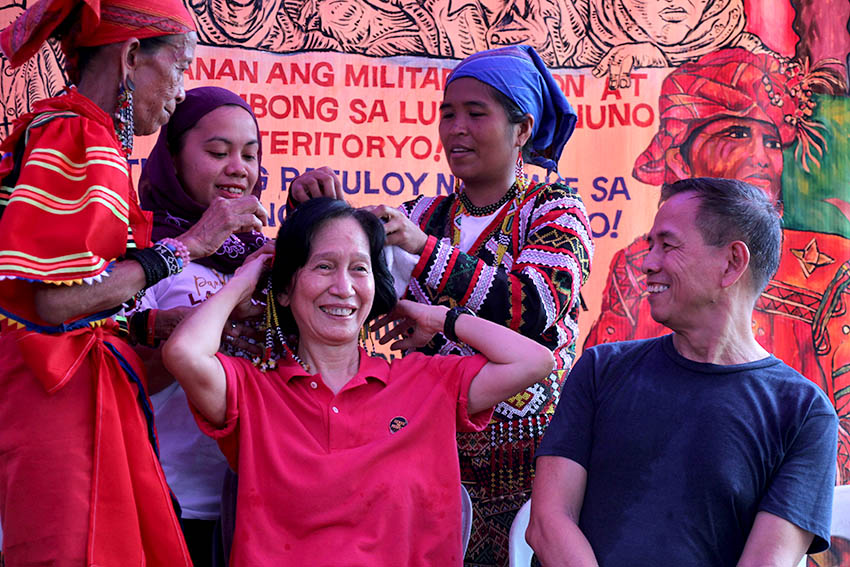 Women Moro and Lumad leaders Bai Ali Indayla and Bai Bibyaon Bigkay give National Democratic Front Consultant Wilma Tiam zon a 's uwat,' a traditional headdress as a token of gratitude for her support on their plightin a peace forum held Wednesday, Oct. 26 at the University of the Philippines Diliman. (Paulo C. Rizal/davaotoday.com)