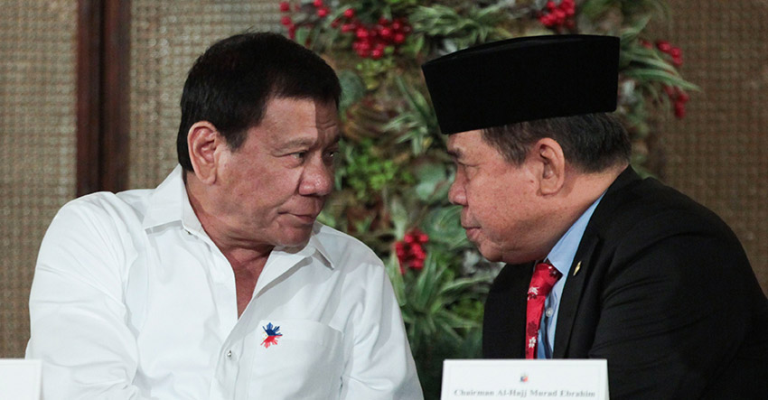 President Rodrigo Roa Duterte chats with Moro Islamic Liberation Front (MILF) Chairman Al Haj Murad Ebrahim on the sidelines of the signing ceremony for the Executive Order reconstituting the Bangsamoro Transition Commission in Malacañan on November 7. (King Rodriguez/Presidential Photo)