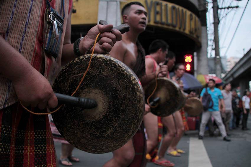 GONG PLAYERS. Tribal men of Cordillera People's Alliance wear traditional vestments as they play the traditional instrument, gong, during the protest march.