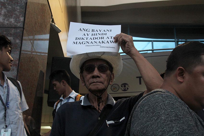 Award-winning writer Don Pagusara joins the candle lighting ceremony conducted by the students of Ateneo de Davao University to condemn the hero's burial of former President Ferdinand Marcos on Monday, November 21 in front of Ateneo de Davao University in Roxas Avenue. Pagusara was among the thousands of activists who were abducted, tortured, and jailed during the Martial Law.(Paulo C. Rizal/davaotoday.com) 