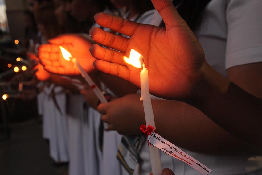 YOUTH VS MARTIAL LAW.  Students of the Ateneo de Davao University light candles on Monday, Nov. 21 to condemn the hero's burial of the former president Ferdinand Marcos.  (Paulo C. Rizal/davaotoday.com) 