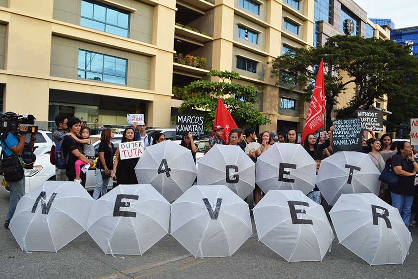 NEVER FORGET. Members of the Konsensya Dabaw, a group opposing the burial of former President Ferdinand Marcos bring their creative umbrellas to show to the public their stand on the Marcos burial issue. (Medel V. Hernani/davaotoday.com)
