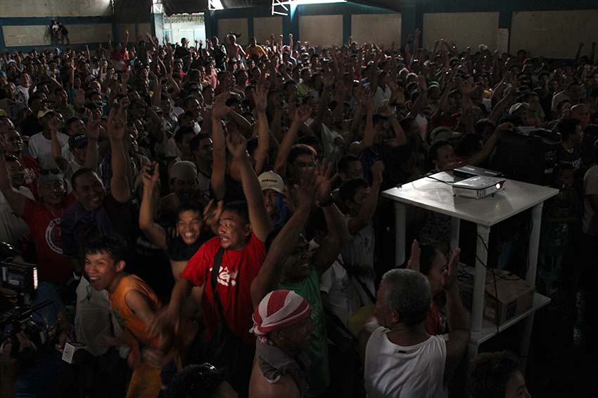 ELATED FANS. Hundreds of supporters inside the Bangkerohan Multi-purpose gym in Barangay 5-A, Davao City jump with joy as boxing champ Manny Pacquiao scores a unanimous decision over Jessie Vargas.  Pacquaio, who is also a Senator, claims the World Boxing Organization welterweight title in Las Vegas on Sunday afternoon, Nov. 6. (Paulo C. Rizal/davaotoday.com)