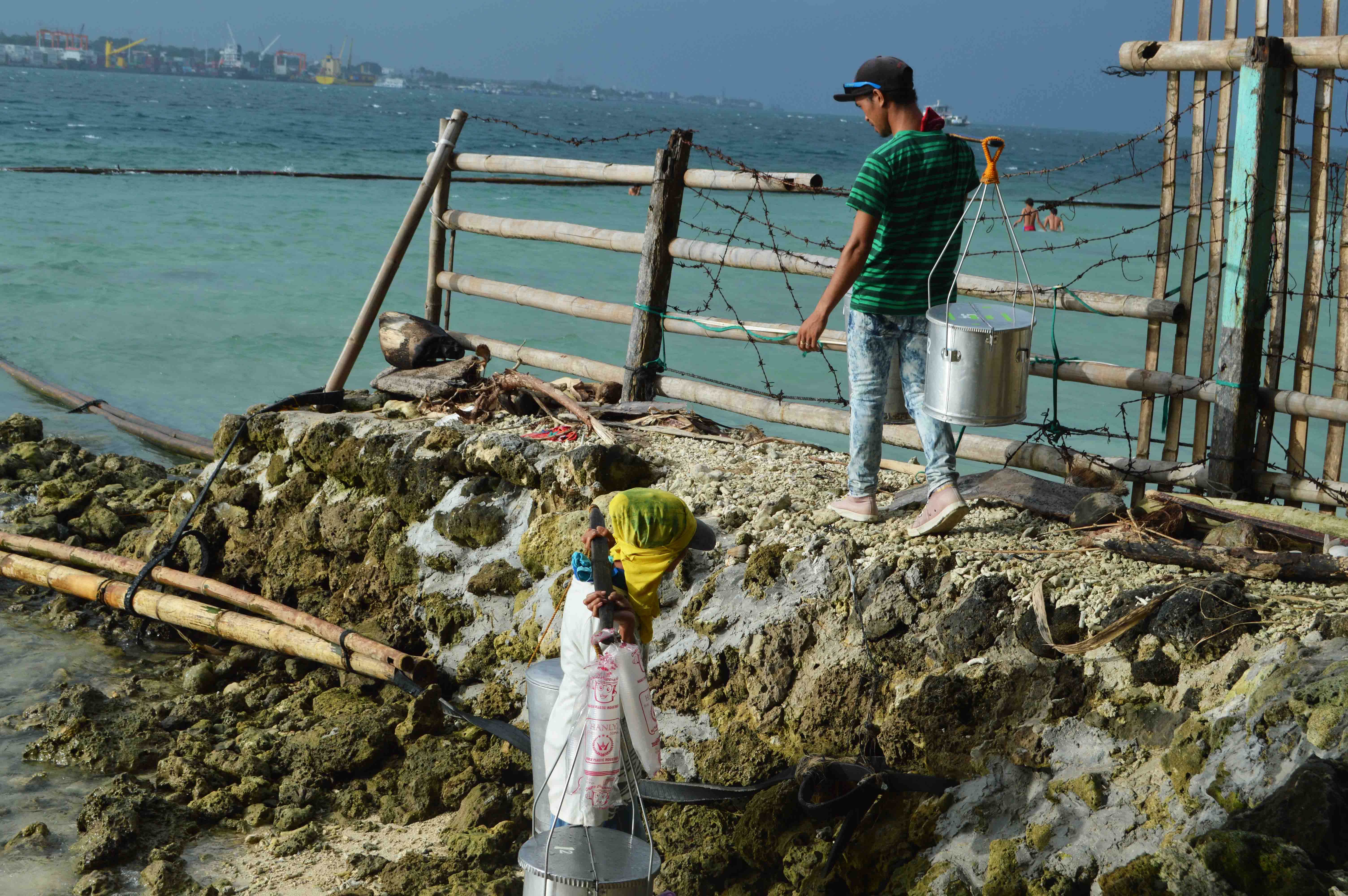 Venders of Taho, a delicacy made from soybeans, come in and out of a resort in the Island Garden City of Samal by passing through the coastlines. In this way, they can save a few money from paying entrance fee. (Medel V. Hernani/davaotoday.com)