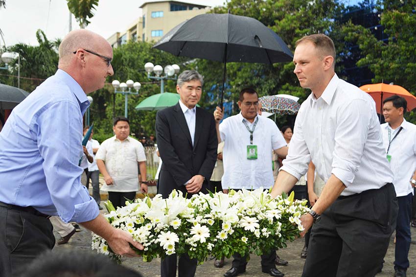 US Ambassador to the Philippines, Sung Y. Kim offers flowers to the victims of night market blast during his visit at the memorial marker on Wednesday, December 14 in Davao City. (Medel V. Hernani/davaotoday.com)