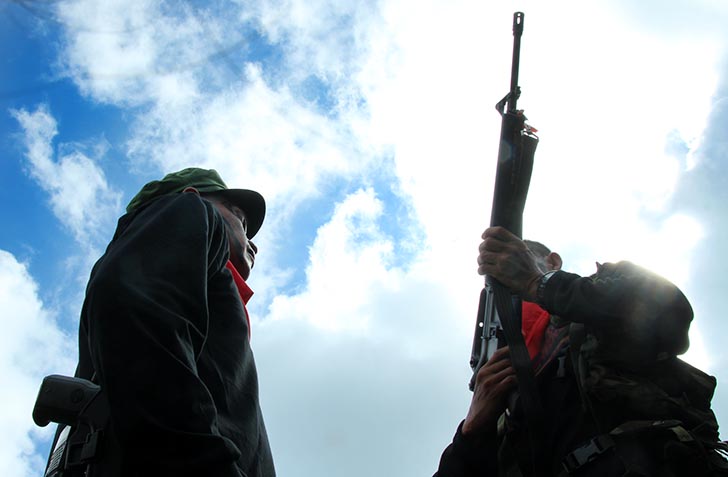 TACTICAL INSPECTION. Ka Yancy (left), commander of the New People's Army's 1st Pulang Bagani Battalion inspects the arms of an NPA fighter during the 48th anniversary celebration of the Communist Party of the Philippines in Barangay Lumiad, Paquibato District, Davao City. (Paulo C. Rizal/davaotoday.com) 