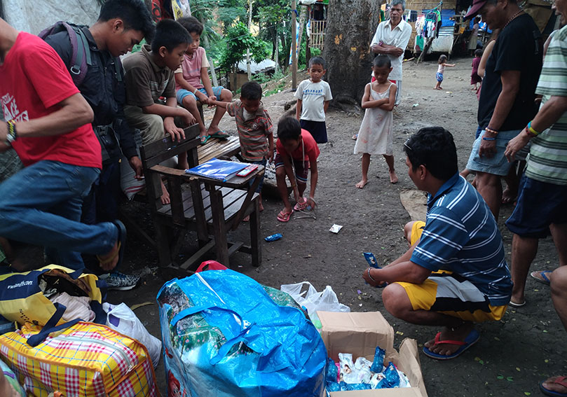 Datu Mintroso Malibato (in blue striped shirt), spokesperson of indigenous peoples group, Karadyawaan prepares the toiletries and clothes for distribution among the remaining Lumad evacuees sheltered inside the Haran compound of the United Church of Christ in the Philippines on Thursday morning, Dec. 22. The relief goods were turned over by members of the National Union of Journalists of the Philippines in Davao City. (Zea Io Ming C. Capistrano/davaotoday.com)