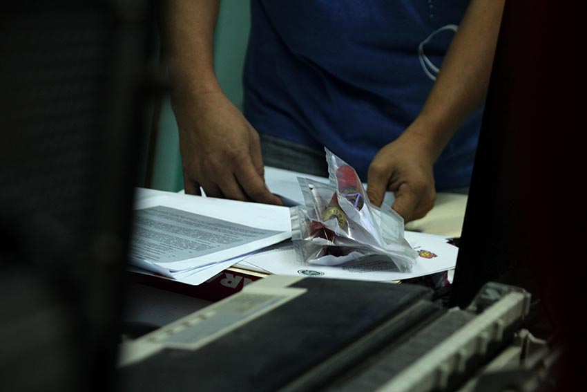 Tagum City Police investigators preparing the shotgun shells in ziplock bags gathered from the crime scene. On Dec. 12, Monday, banana plantation guards of  Lapanday Foods Corporation  shot the farmers, wounding six, two of which are currently in critical condition. (Paulo C. Rizal/davaotoday.com) 