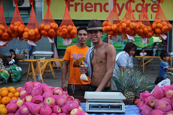 FRUIT SELLER. Yongyong, 19, poses for a picture while selling fruits along Magallanes street in Davao City on Thursday, Dec. 29. Yongyong helps his uncle to earn his keep while classes have yet to resume. (Paulo C. Rizal/davaotoday.com) 