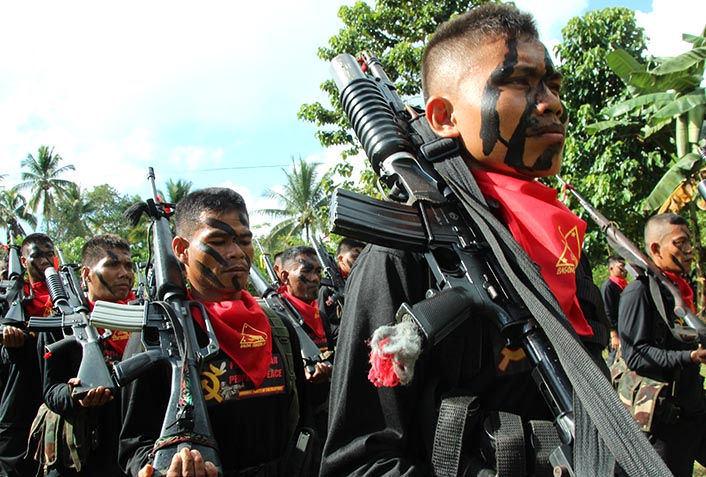 IN FORMATION. The New People's Army's Pulang Bagani Battalion stands in formation for a tactical inspection during the 48th anniversary of the Communist Party of the Philippines on Monday, Dec. 26 in Barangay Lumiad, Paquibato District, Davao City. (Paulo C. Rizal/davaotoday.com) 