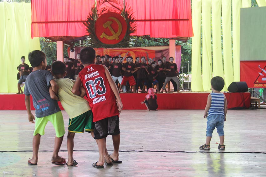 Children who joined the 48th founding anniversary of the Communist Party of the Philippines copy the movements of the cultural performers who have their final stage rehearsal before the program started. (Earl O. Condeza/davaotoday.com) 