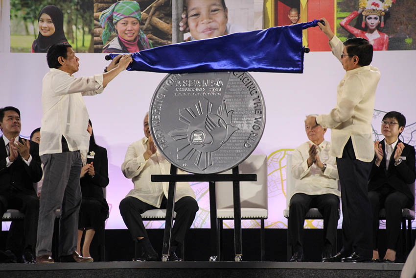 Philippine President and ASEAN 2017 chairman Rodrigo Duterte unveils the commemorative coin specially designed by the Bangko Sentral ng Pilipinas for the 50th anniversary and the Philippine chairmanship of the ASEAN on Sunday, Jan. 15 at the SMX Convention Center in Lanang, Davao City. (Paulo C. Rizal/davaotoday,com) 