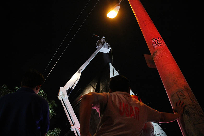 An Urban Search and Rescue personnel from the city government watches as a fireman continues to put the fire that razed a soon to open shopping mall in Barangay Mintal, Davao City on Wednesday night, Jan. 11. The fire started around 4 p.m.(Paulo C. Rizal/davaotoday.com)