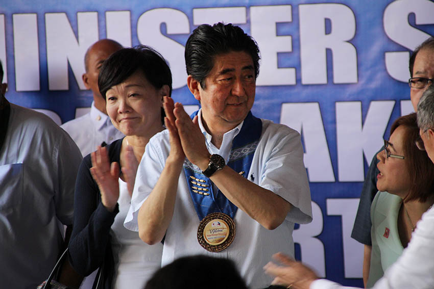 AWED. Japanese Prime Minister Shinzo Abe claps as he witnesses the presentation of at least 1,700 students of the Mindanao Kokusai Daigaku during his visit to the school on Friday, Jan. 13. Beside him is Japan's First Lady, Madame Akie Abe. (Paulo C. Rizal/davaotoday.com)  