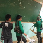 HANDYMEN. Communist guerillas help fix one of the primary schools damaged by typhoon Pablo in Compostela Valley Province. (davaotoday.com photo by Ace R. Morandante)