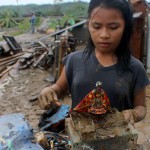 FAITH. A child salvages her Sto. Niňo on Tuesday in Montevista, Compostela Valley. She’s one of the survivors when typhoon Pablo destroyed houses in Linoan village. (davaotoday.com photo by Ace R. Morandante)