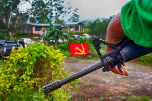 ON GUARD. A member of the New People’s Army Rhyme Petalcorin Command stands guard during the release of Police Officer 3 Ruben Nojapa, Jr. Tuesday in Mawab, Compostela Valley. (davaotoday.com photo by Medel V. Hernani)