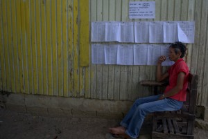 LONESOME. An election officer waits for remaining voters to come at a precinct in Paquibato around 12 noon. (davaotoday.com photo by Earl O. Condeza)