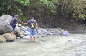 COVERAGE. Reporters have to cross a river to cover the election in far-flung Paquibato. (davaotoday.com photo by Earl O. Condeza)