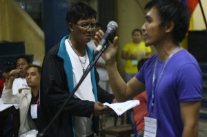 INTERRUPTION. A man (center) believed to be a supporter of defeated re-electionist Robert Olanolan tries to disrupt the counting with a letter demanding for a recount. The head of the canvassing board, Rosauro Camacho (right), orders the cops to escort the man away. (davaotoday.com photo by John Rizle L. Saligumba)