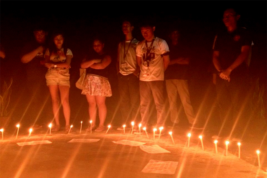 Students light up candles for UP campuses affected by Yolanda